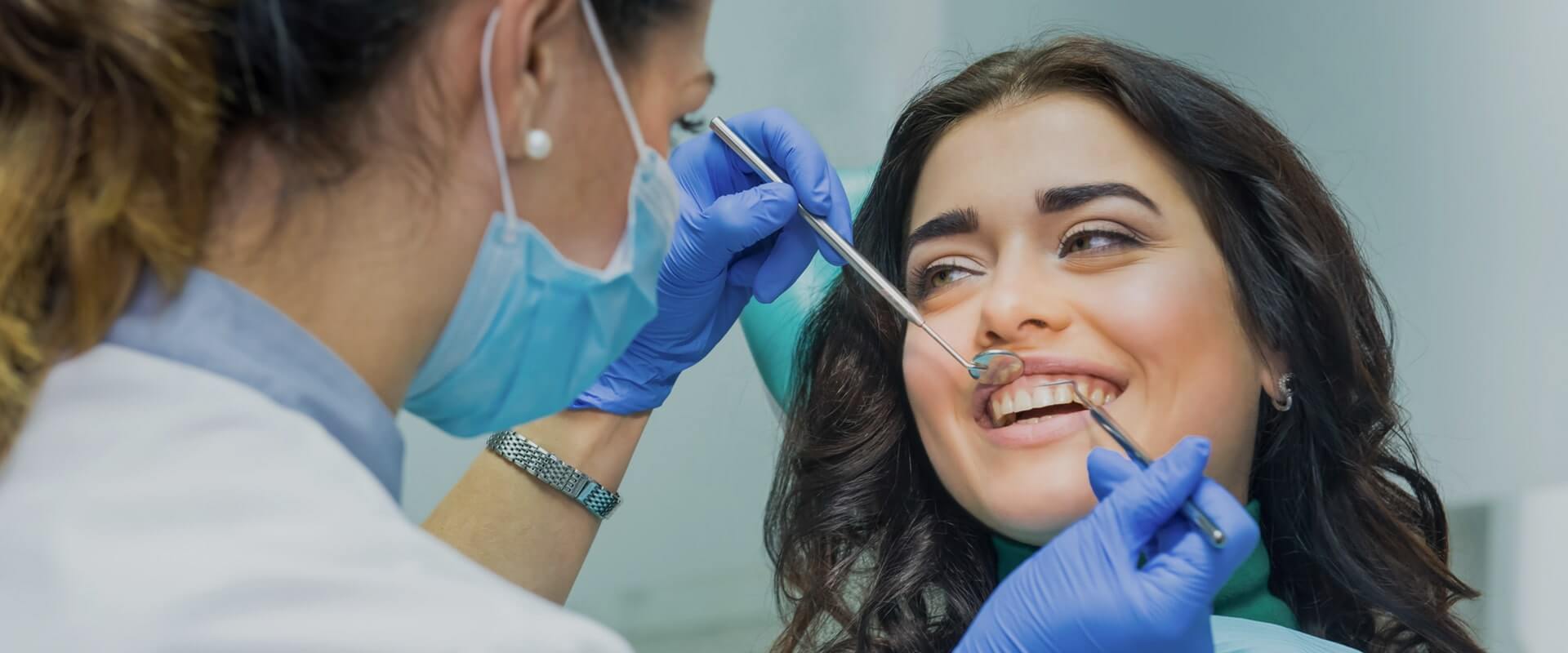 Woman dentist working at her patients teeth stock photo