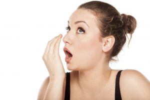 young woman checking her breath stock photo