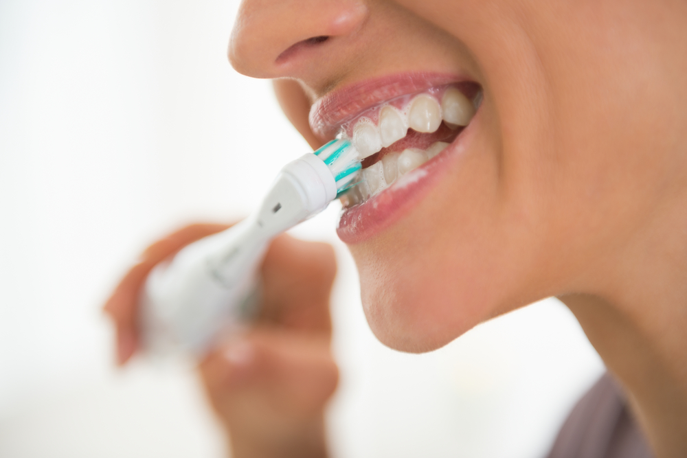 Closeup on young woman brushing teeth stock photo