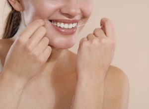 Woman Using Dental Floss stock photo