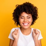 A woman smiling brightly with self-confidence stock photo