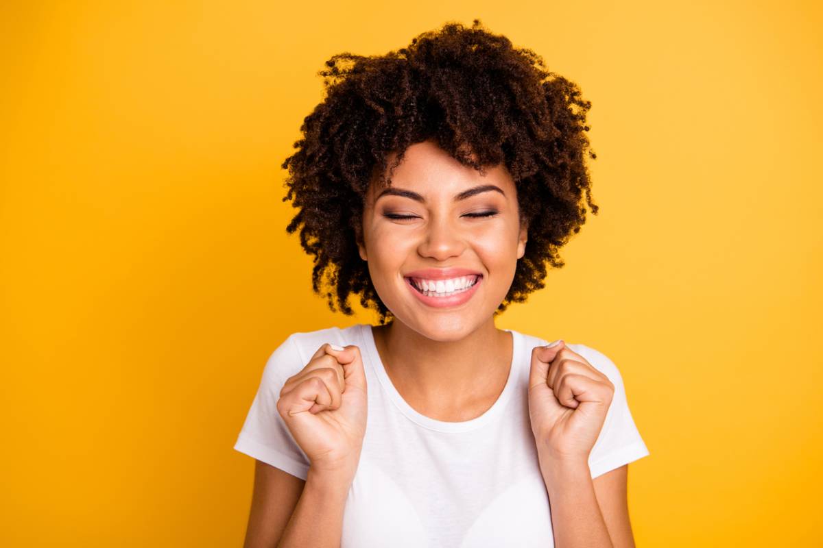 A woman smiling brightly with self-confidence stock photo