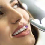 Woman having an important regular dental cleaning procedure stock photo