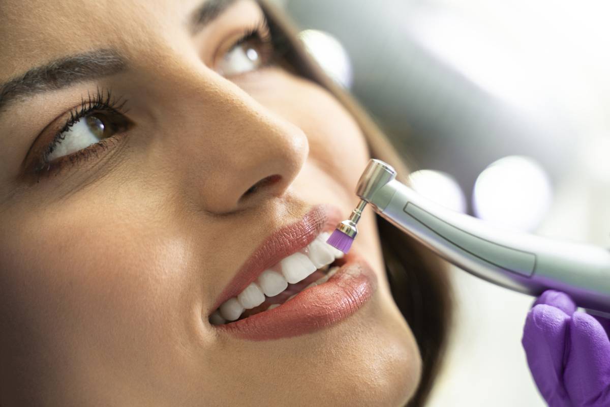 Woman having an important regular dental cleaning procedure stock photo