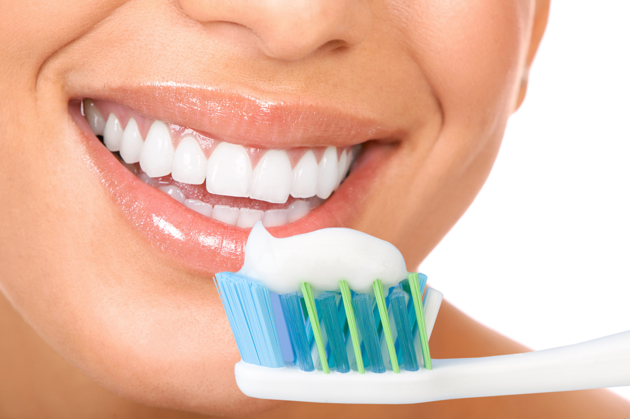 Smiling young woman with healthy teeth holding a tooth-brush stock photo